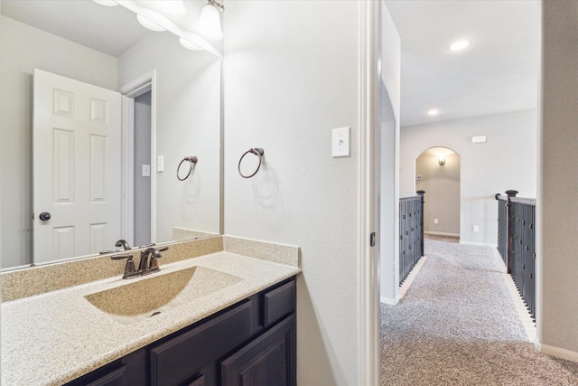 bathroom with recessed lighting, baseboards, and vanity