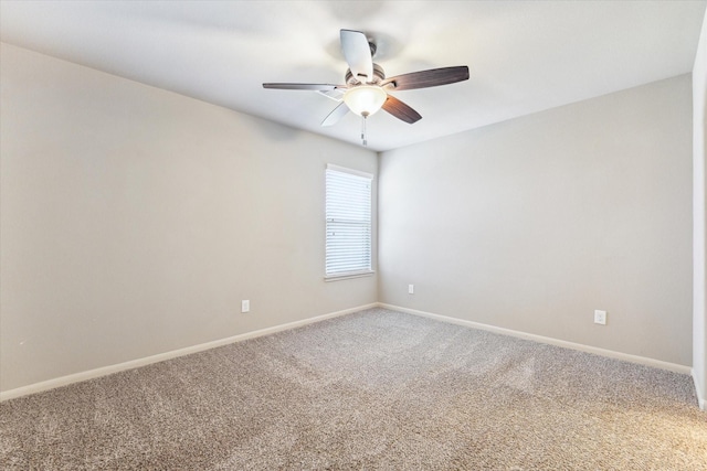 spare room with baseboards, ceiling fan, and carpet flooring