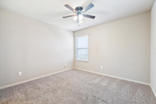 unfurnished room with ceiling fan, baseboards, and carpet