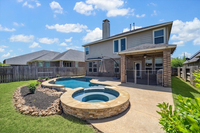 view of pool featuring a patio, a ceiling fan, a fenced backyard, a pool with connected hot tub, and a lawn