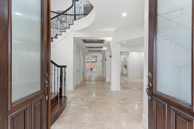 foyer featuring baseboards, stairway, and recessed lighting