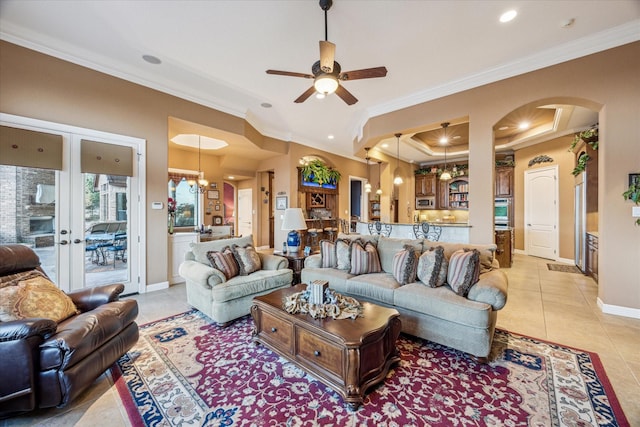 living area with arched walkways, light tile patterned flooring, and crown molding