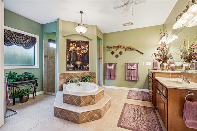 full bath featuring visible vents, baseboards, a garden tub, tile patterned flooring, and vanity