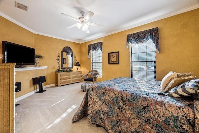 carpeted bedroom with ornamental molding, visible vents, baseboards, and a ceiling fan