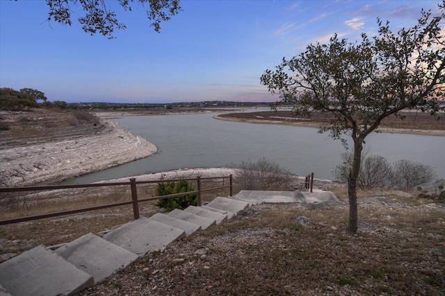 property view of water featuring fence