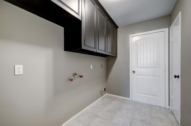 washroom with hookup for a gas dryer, cabinet space, light tile patterned floors, baseboards, and hookup for a washing machine