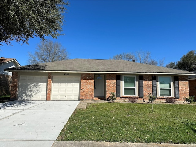 ranch-style home with a front yard, concrete driveway, brick siding, and an attached garage