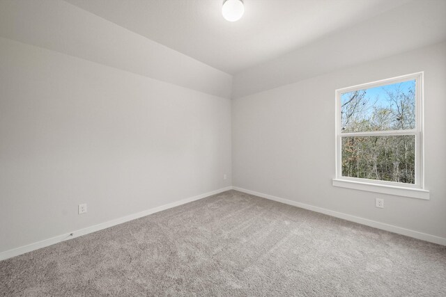 spare room with carpet and baseboards