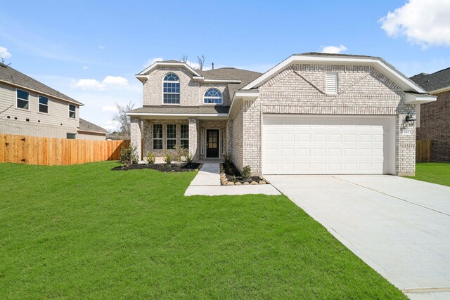 view of front facade with a front yard, brick siding, and fence