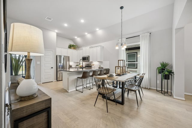 18823 Cypress Meadow Ct, Magnolia, TX 77355 - dining area featuring light wood-style floors, recessed lighting, high vaulted ceiling, and a chandelier