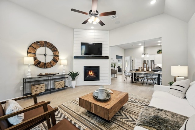 18823 Cypress Meadow Ct, Magnolia, TX 77355 - living room featuring light wood-style flooring, a ceiling fan, recessed lighting, a large fireplace, and lofted ceiling