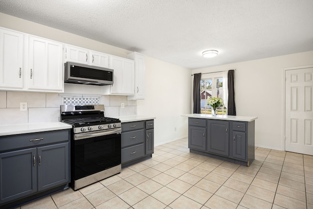 kitchen featuring appliances with stainless steel finishes, light countertops, gray cabinets, and white cabinets