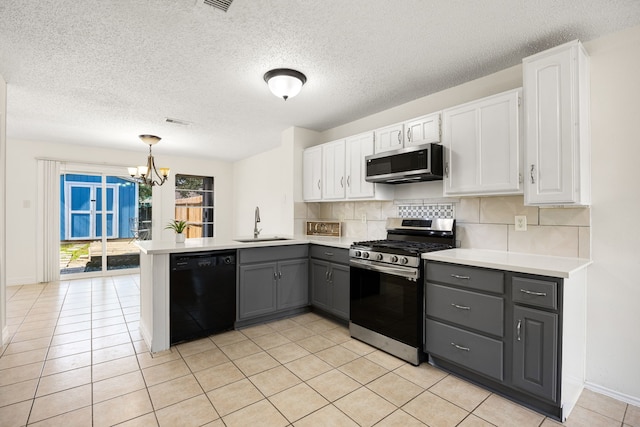 kitchen with gray cabinets, appliances with stainless steel finishes, white cabinetry, a sink, and a peninsula