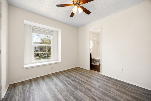 empty room featuring a ceiling fan, a textured ceiling, baseboards, and wood finished floors