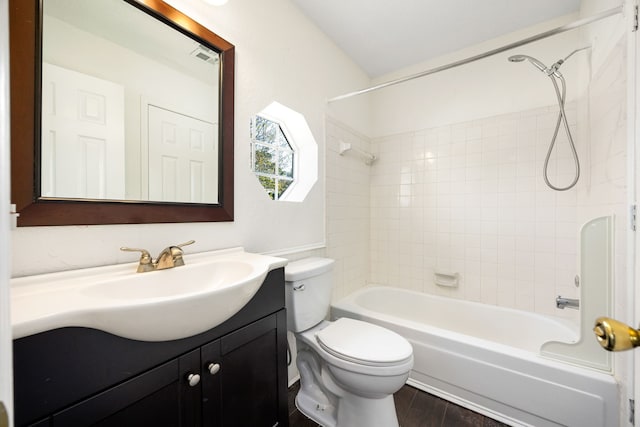 full bath with shower / tub combination, vanity, toilet, and wood finished floors