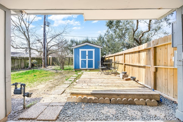 exterior space featuring an outbuilding, a fenced backyard, and a storage shed