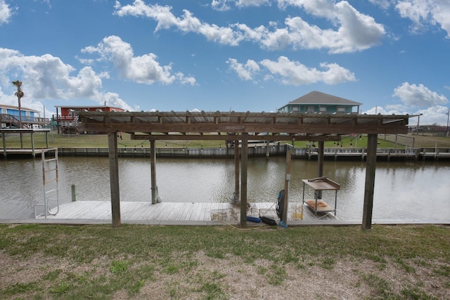 view of dock with a lawn and a water view