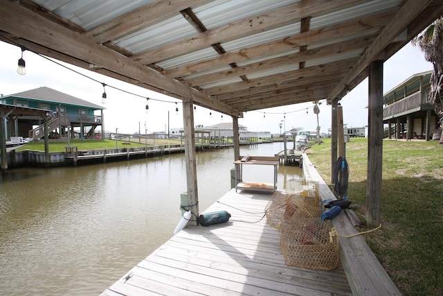 view of dock featuring a water view and a yard