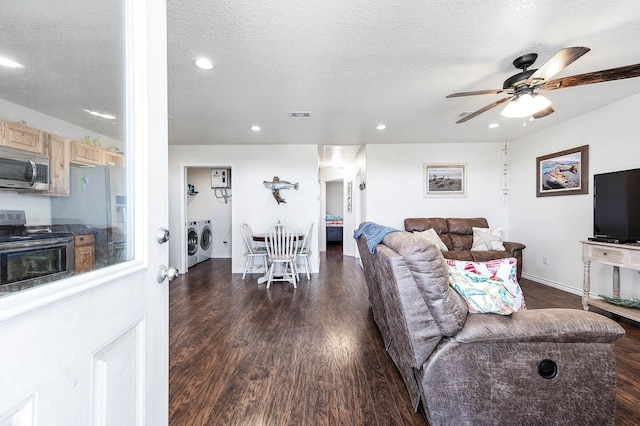 1217 County Road 201, Sargent, TX 77414 - living area featuring independent washer and dryer, dark wood-type flooring, a textured ceiling, visible vents, and ceiling fan