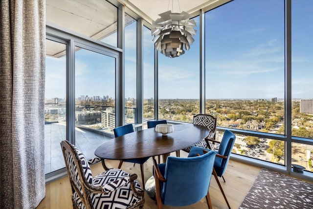 sunroom featuring a view of city and a ceiling fan