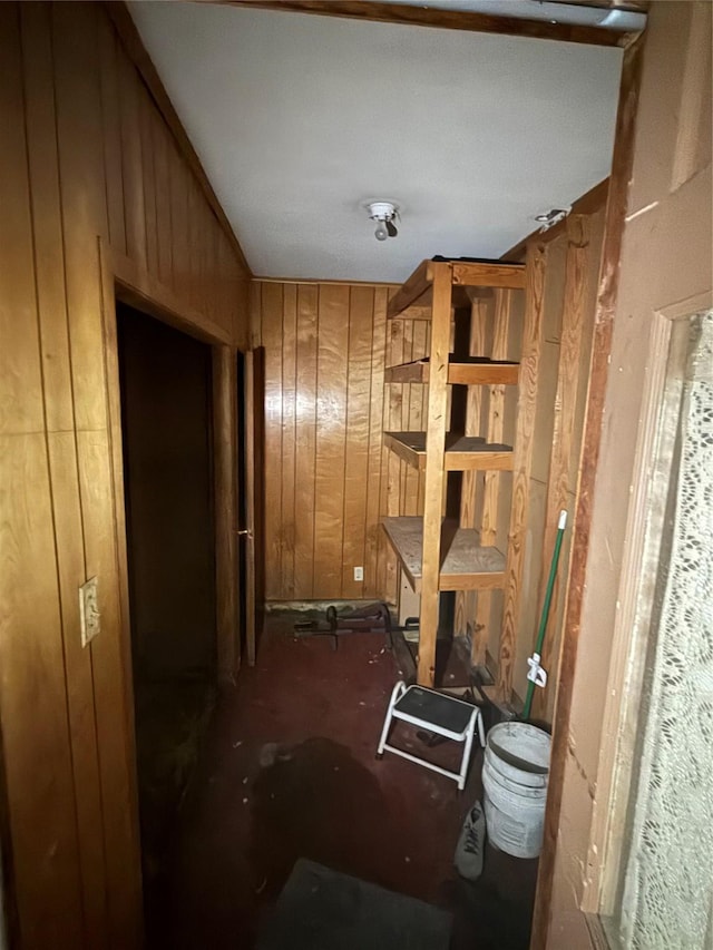 hallway featuring wooden walls