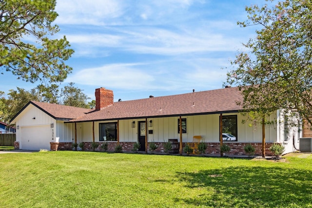 ranch-style house with an attached garage, brick siding, a front lawn, board and batten siding, and a chimney