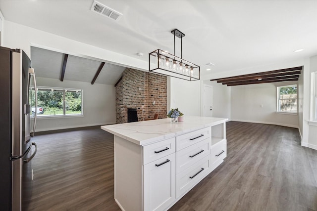 kitchen featuring visible vents, white cabinets, lofted ceiling with beams, open floor plan, and stainless steel refrigerator with ice dispenser