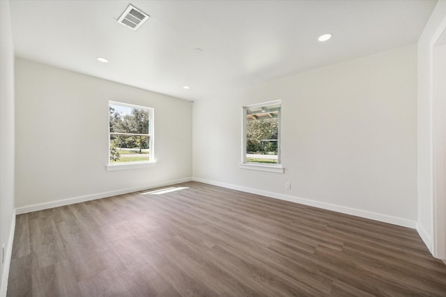 spare room featuring recessed lighting, visible vents, baseboards, and wood finished floors