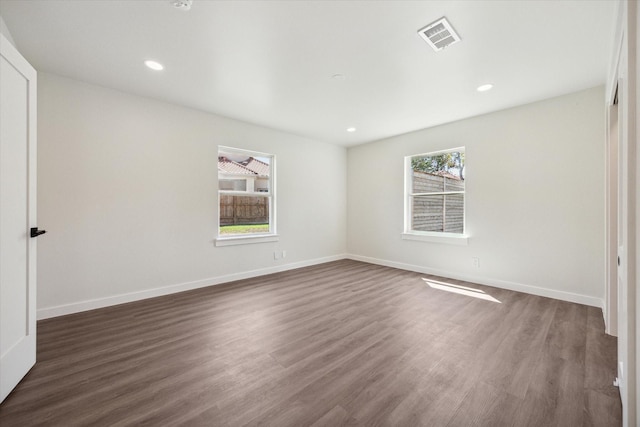 interior space featuring recessed lighting, wood finished floors, visible vents, and baseboards