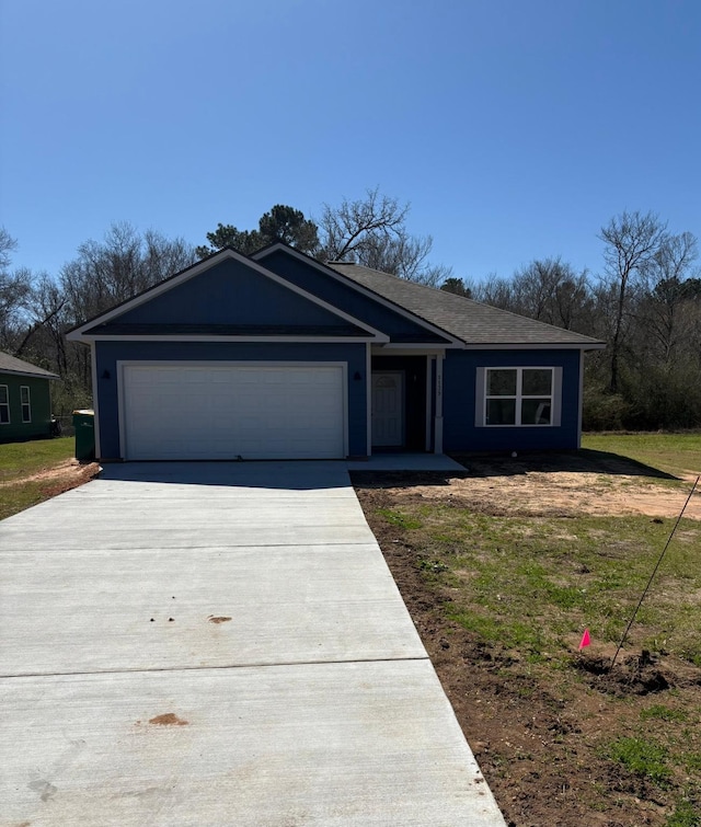 ranch-style home featuring a garage and concrete driveway