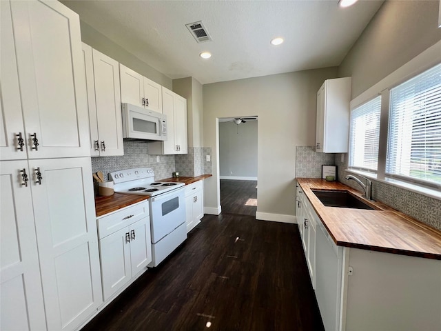 kitchen featuring a sink, white appliances, wood counters, and visible vents