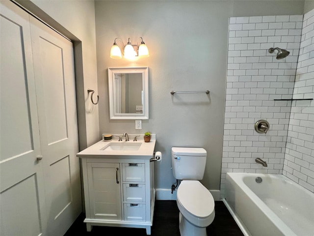 bathroom with toilet, baseboards, shower / bathing tub combination, and vanity