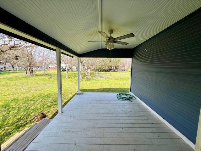 wooden deck with ceiling fan and a yard