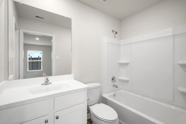 bathroom featuring toilet, vanity, visible vents, and shower / bathing tub combination