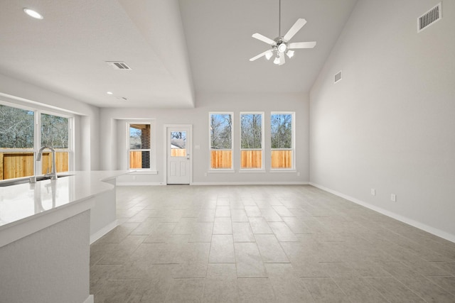 289 Galant Fox Way, New Caney, TX 77357 - unfurnished living room featuring a sink, visible vents, and baseboards