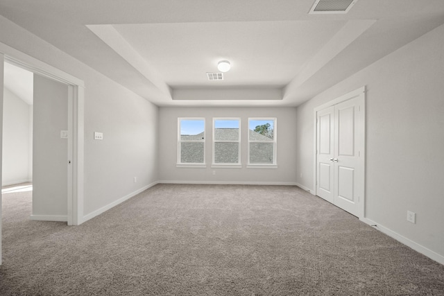 289 Galant Fox Way, New Caney, TX 77357 - empty room with carpet floors, a tray ceiling, and visible vents