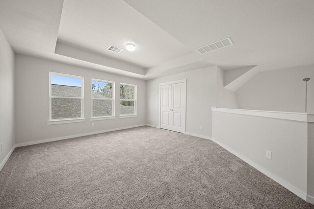 289 Galant Fox Way, New Caney, TX 77357 - unfurnished room with a tray ceiling, carpet, visible vents, and baseboards