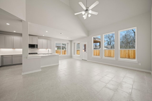 289 Galant Fox Way, New Caney, TX 77357 - interior space featuring a ceiling fan, recessed lighting, high vaulted ceiling, and baseboards
