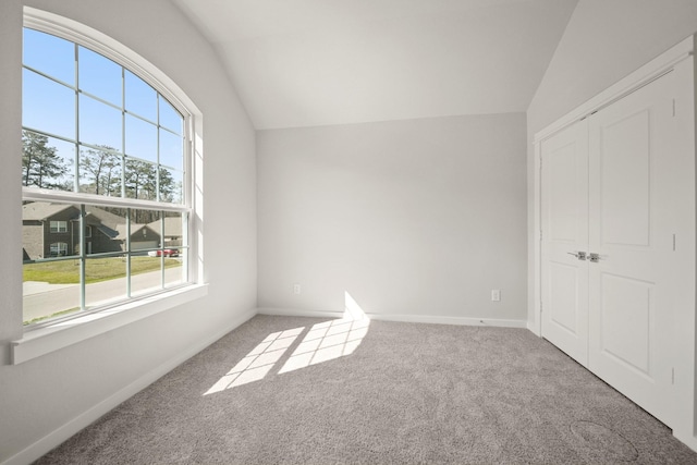 289 Galant Fox Way, New Caney, TX 77357 - unfurnished bedroom featuring carpet floors, lofted ceiling, a closet, and baseboards