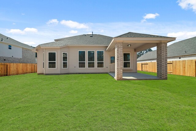 289 Galant Fox Way, New Caney, TX 77357 - rear view of house featuring a fenced backyard, a lawn, and a patio