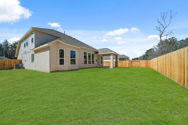 289 Galant Fox Way, New Caney, TX 77357 - back of house with brick siding, a lawn, a fenced backyard, and central air condition unit