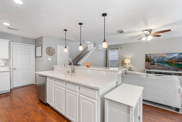 kitchen featuring a sink, visible vents, open floor plan, stainless steel dishwasher, and dark wood finished floors