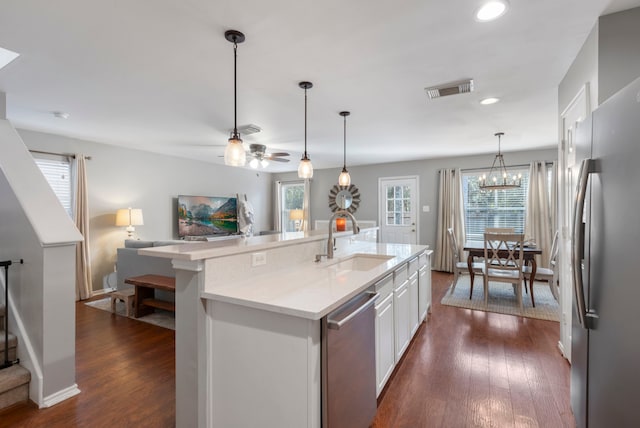 kitchen featuring dark wood-style floors, light countertops, visible vents, appliances with stainless steel finishes, and a sink