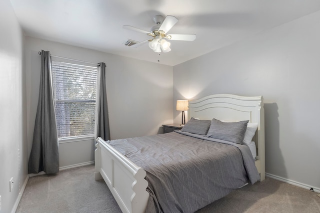 bedroom featuring light colored carpet, visible vents, ceiling fan, and baseboards