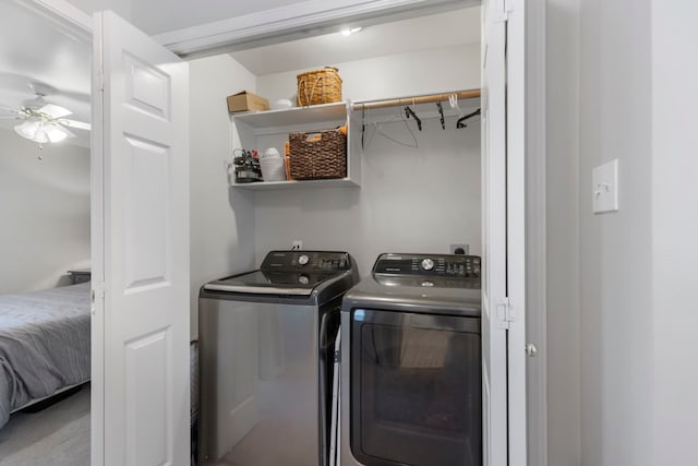 clothes washing area with washer and dryer, laundry area, and ceiling fan