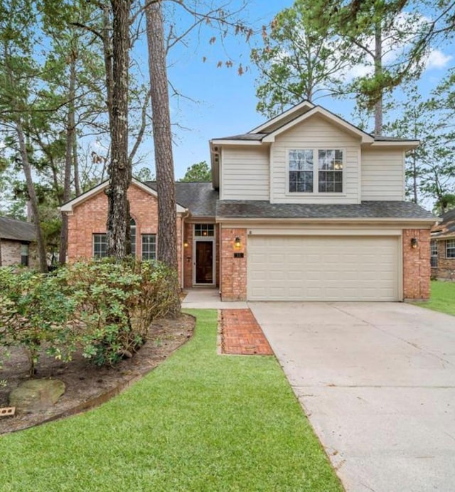 traditional-style home featuring a garage, a front yard, concrete driveway, and brick siding