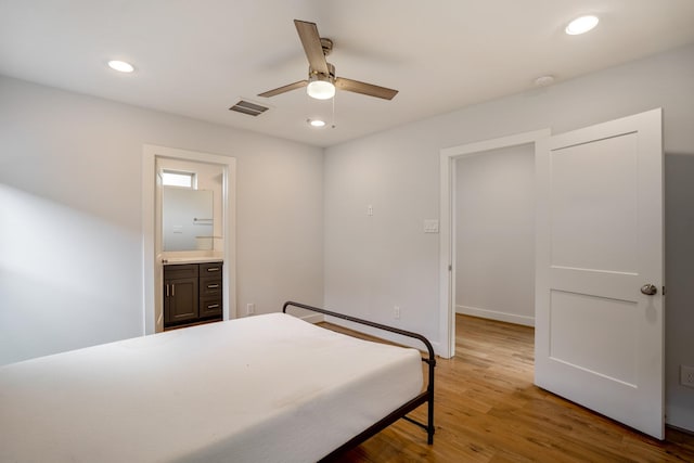 bedroom with ensuite bathroom, ceiling fan, recessed lighting, wood finished floors, and visible vents