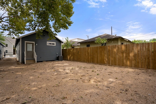 exterior space with entry steps, fence, and central AC