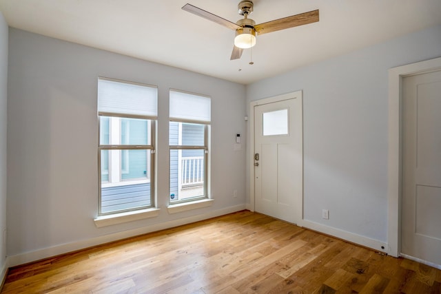 entrance foyer with a ceiling fan, light wood-type flooring, and baseboards