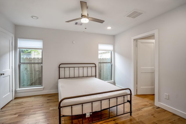 bedroom featuring light wood-type flooring, visible vents, and recessed lighting